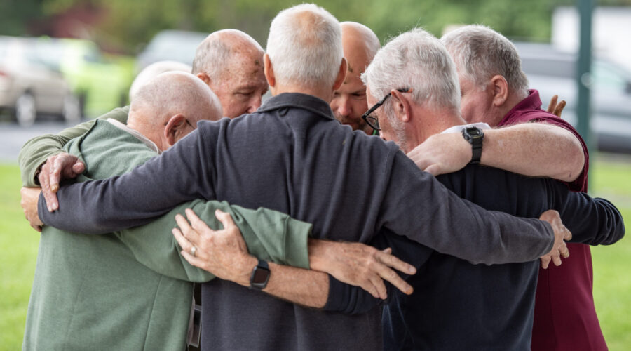 men in a group hug